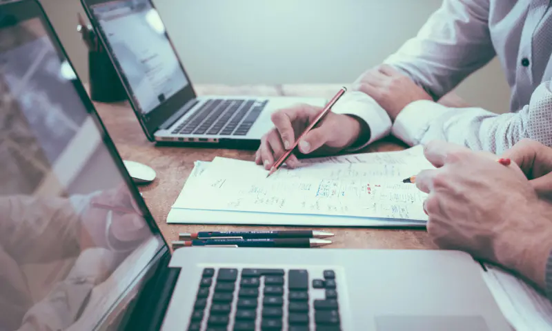 Insurance expert explaining claim details to customer at a desk